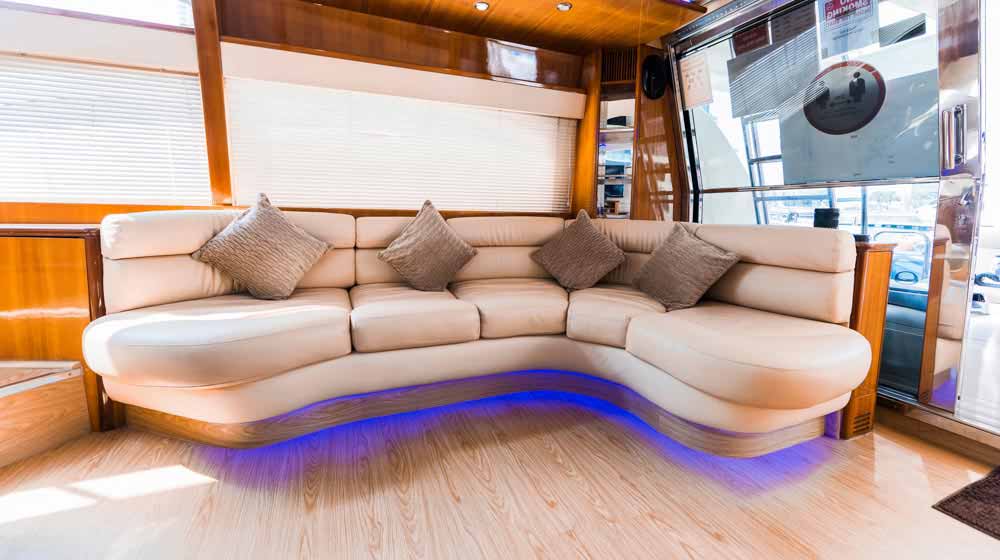 yacht saloon with lovely interiors, leather sofa, cushions, good lights